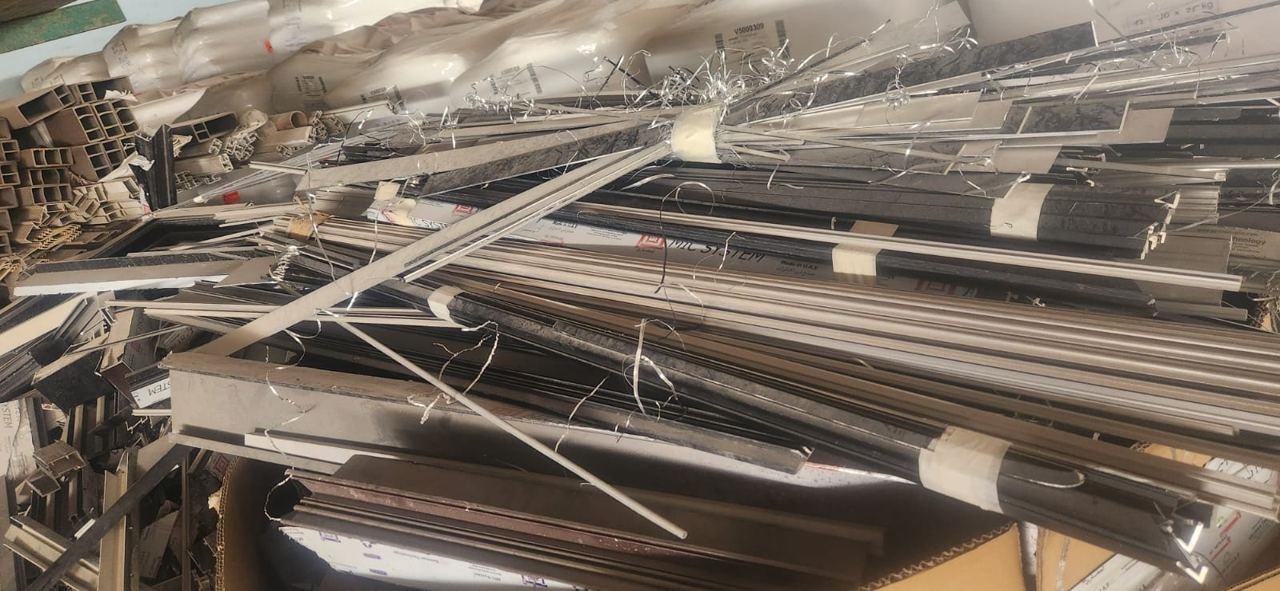 Long aluminium and metal offcuts stacked in a sorting area
