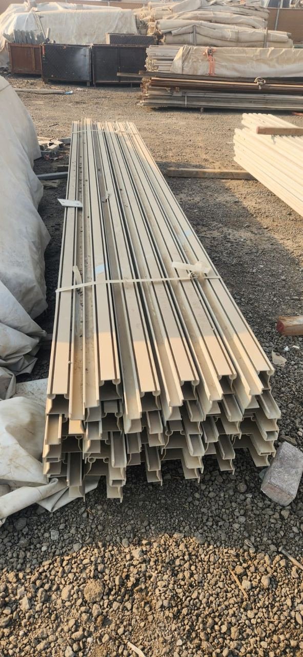 Long bundled metal profiles stored outdoors on a storage yard