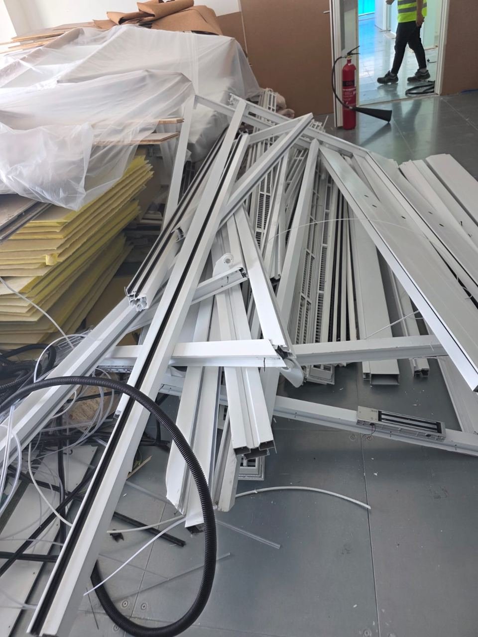 White aluminium profiles and frames piled inside a building during renovation
